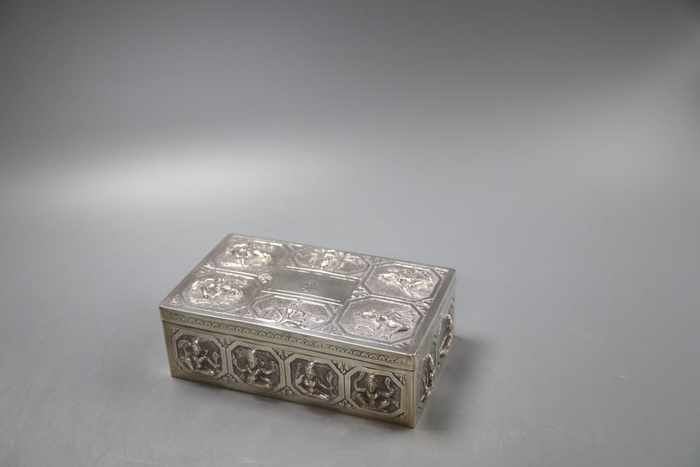 An Indian white metal cigarette box embossed with deities,15.5cm